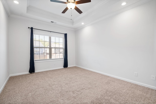 spare room with ceiling fan, a raised ceiling, crown molding, and carpet floors