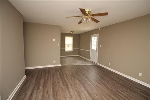 unfurnished room with dark wood-type flooring and ceiling fan