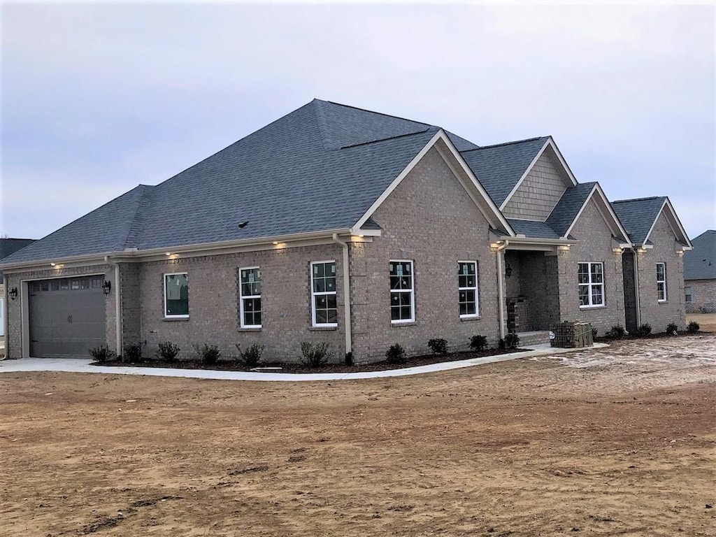 view of front facade with a garage and central AC unit