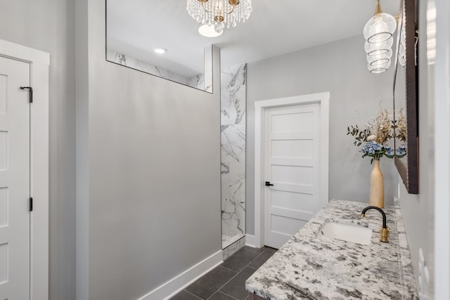 bathroom with a shower, vanity, and tile patterned floors