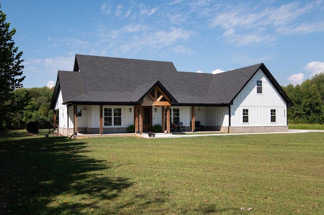 modern farmhouse style home with a front lawn and a patio area