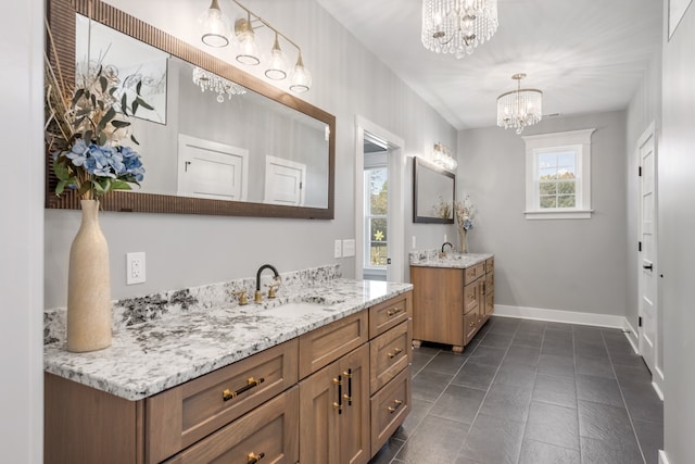 bathroom featuring tile patterned flooring, vanity, and an inviting chandelier