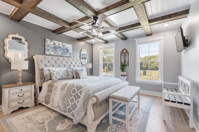 bedroom with beamed ceiling, hardwood / wood-style flooring, coffered ceiling, and ceiling fan