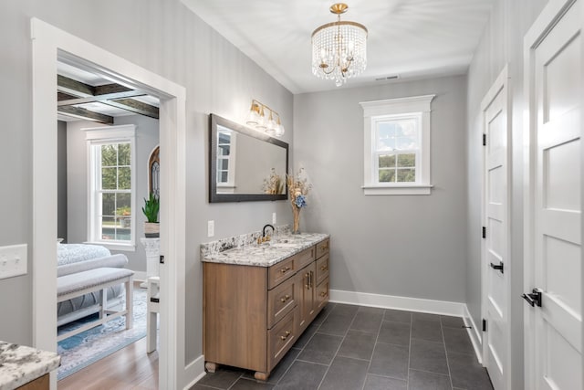 bathroom featuring tile patterned flooring, a chandelier, beamed ceiling, coffered ceiling, and vanity