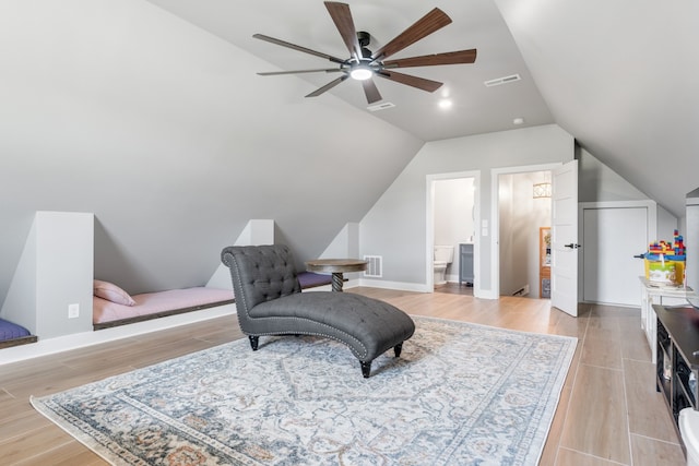 sitting room featuring light wood-type flooring, vaulted ceiling, and ceiling fan