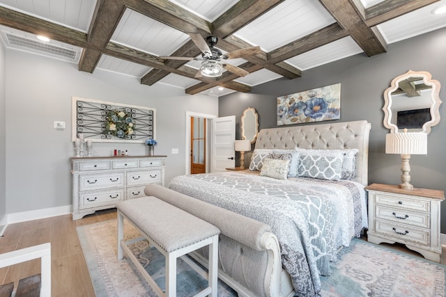 bedroom with ceiling fan, coffered ceiling, beamed ceiling, and light hardwood / wood-style floors