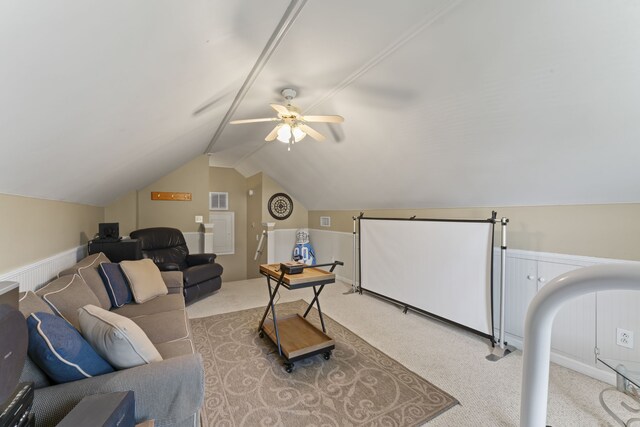 carpeted living room featuring vaulted ceiling and ceiling fan