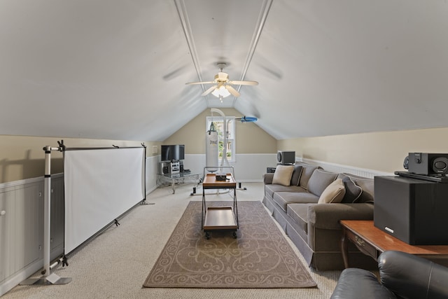 living room with lofted ceiling, ceiling fan, and carpet