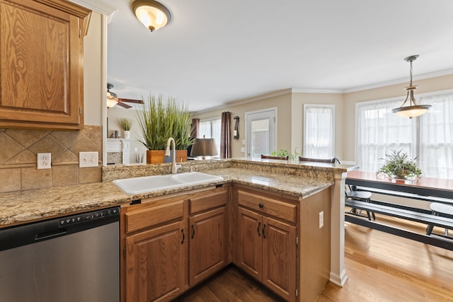 kitchen featuring dishwasher, hardwood / wood-style flooring, sink, and ceiling fan