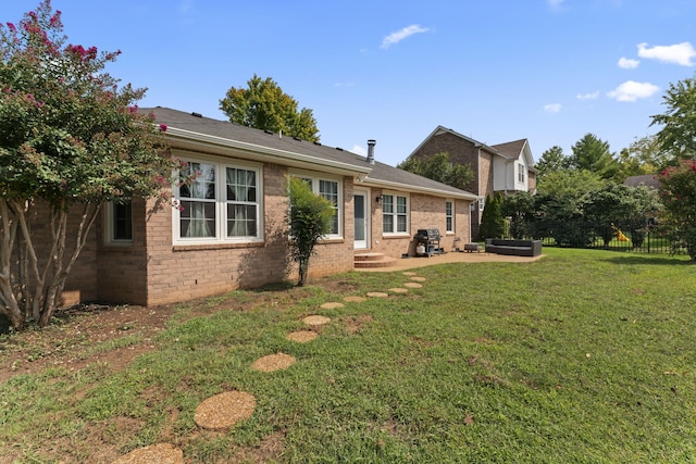 rear view of property featuring a yard