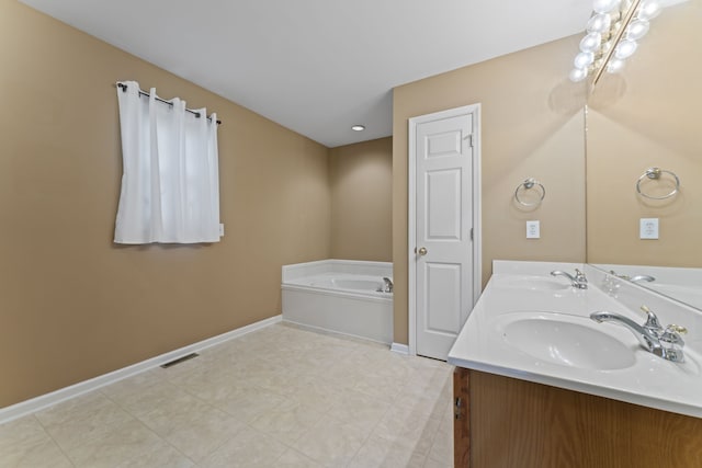 bathroom with vanity and a bath