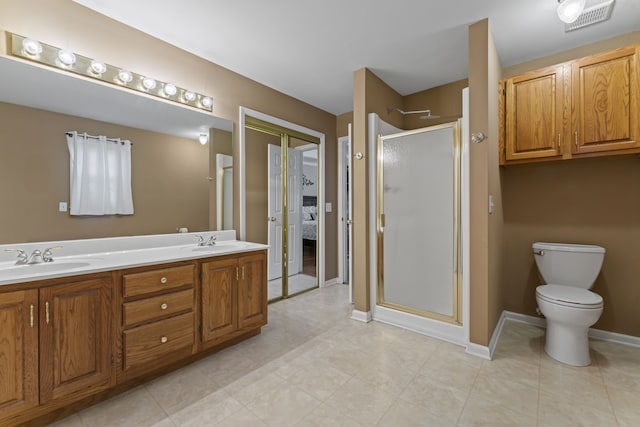 bathroom with toilet, a shower with door, and vanity