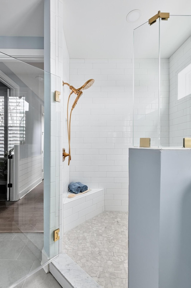 bathroom featuring tiled shower and tile patterned floors