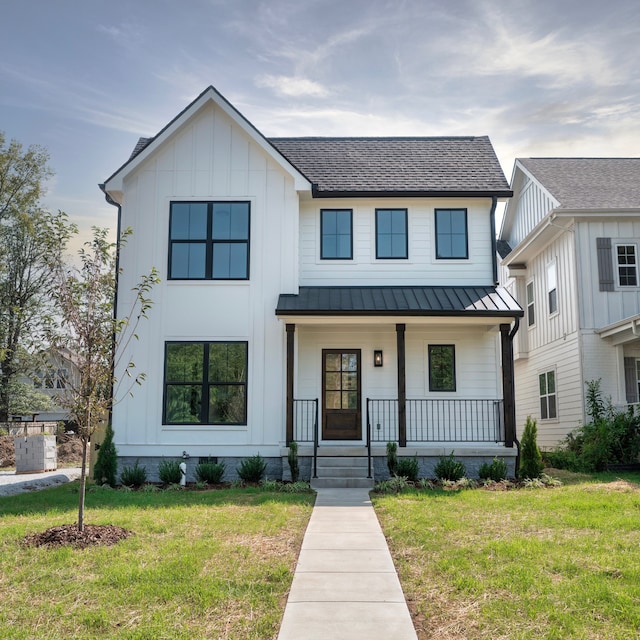 modern farmhouse featuring covered porch and a front lawn