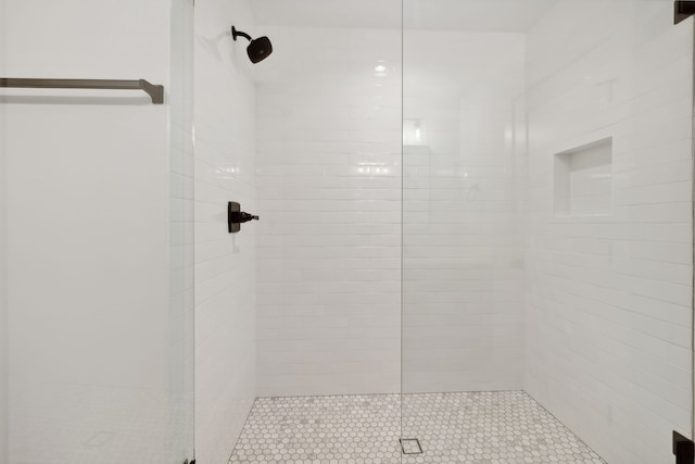 bathroom with a tile shower