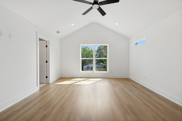 spare room featuring ceiling fan, light wood-type flooring, and vaulted ceiling