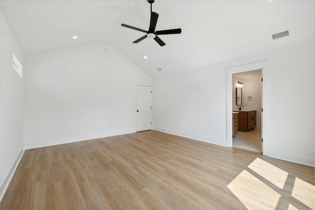 spare room with light wood-type flooring, ceiling fan, and vaulted ceiling