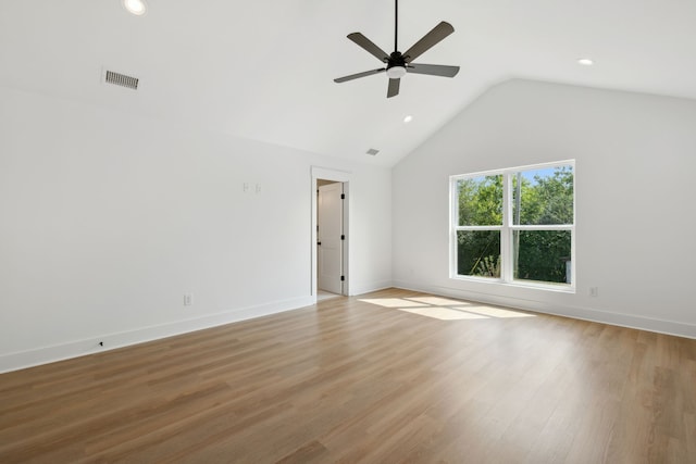 spare room featuring vaulted ceiling, ceiling fan, and light hardwood / wood-style floors