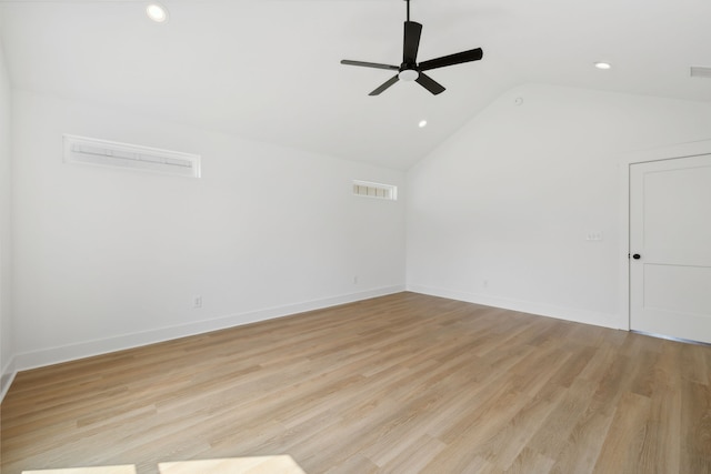 empty room with lofted ceiling, ceiling fan, and light hardwood / wood-style flooring