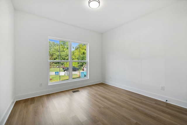 spare room with hardwood / wood-style floors