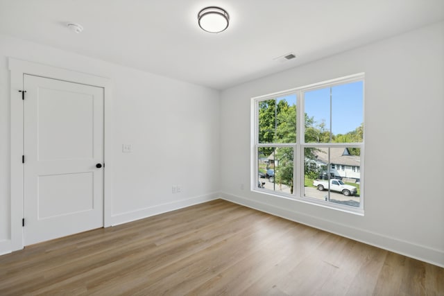 spare room featuring light hardwood / wood-style floors