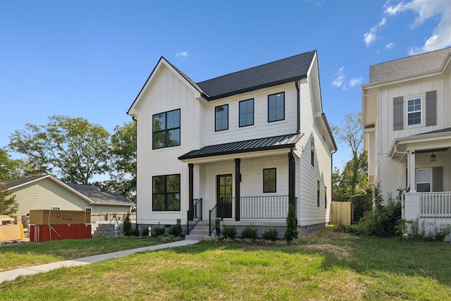 modern farmhouse with a front lawn and a porch