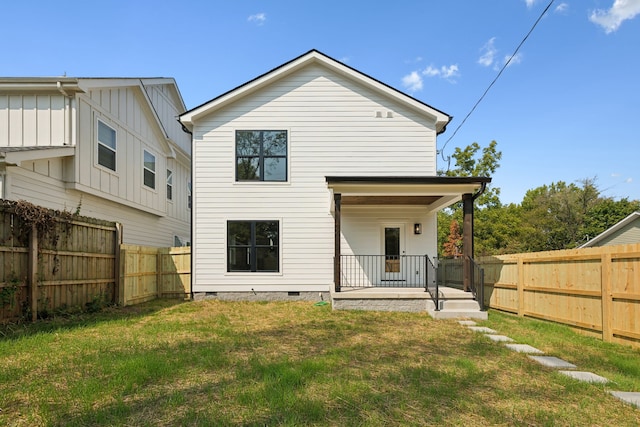 back of house featuring a yard