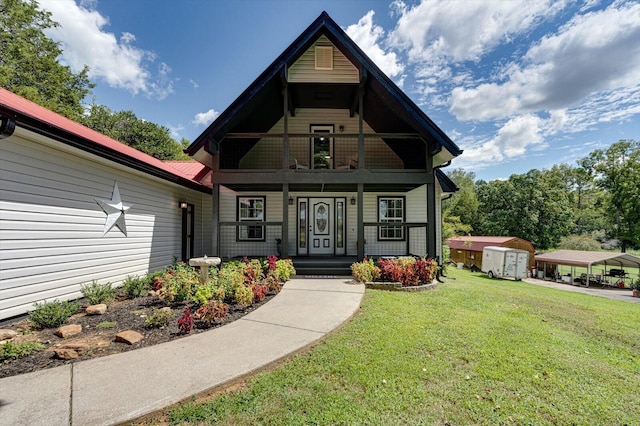 view of front of home featuring a shed, covered porch, and a front yard