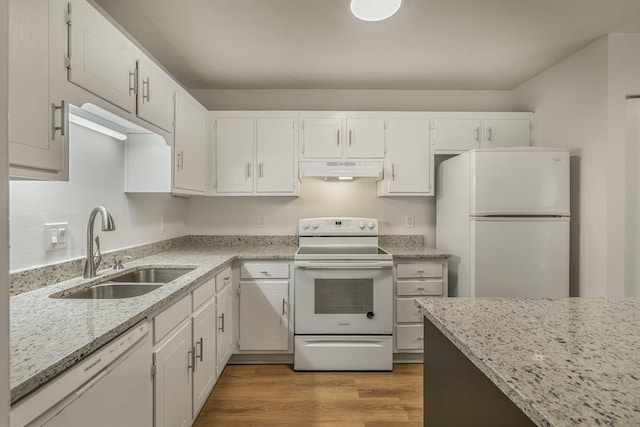 kitchen with under cabinet range hood, wood finished floors, white appliances, white cabinetry, and a sink