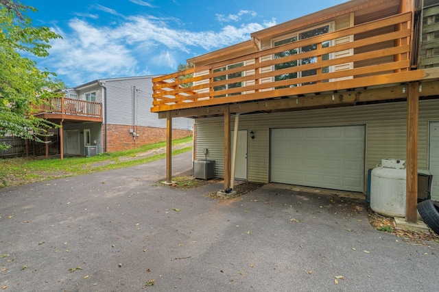 garage with cooling unit and driveway