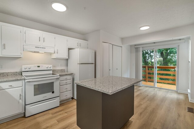 kitchen with white electric range, light stone counters, light hardwood / wood-style flooring, and a kitchen island