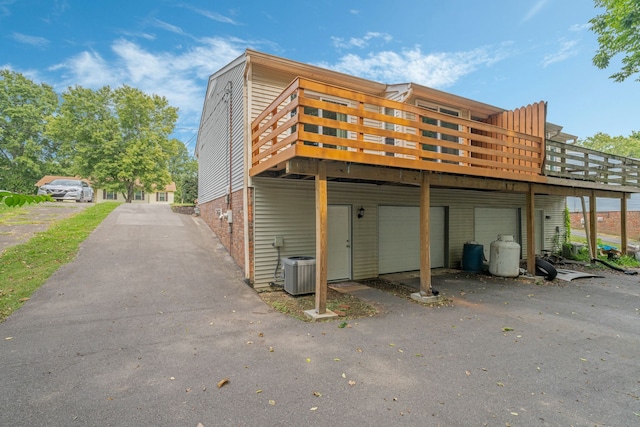 exterior space featuring cooling unit and a garage