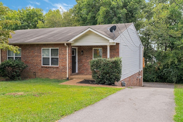 single story home with brick siding and a front yard