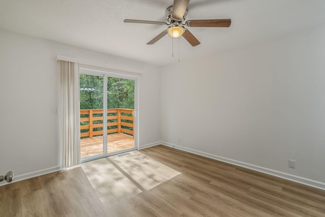 unfurnished room featuring ceiling fan, baseboards, and wood finished floors