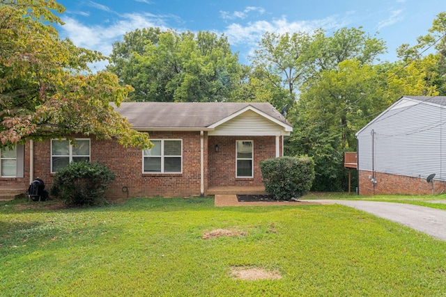 view of front of property with a front lawn and brick siding