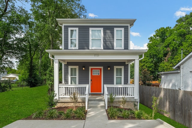 view of front of home with a front yard and a porch