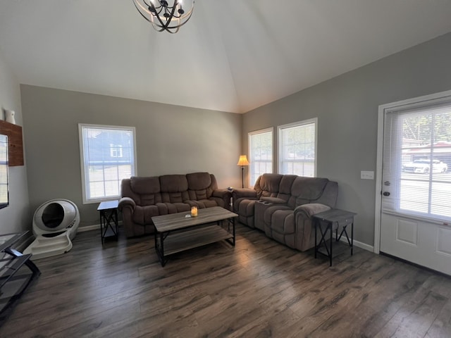 living room featuring dark hardwood / wood-style floors, an inviting chandelier, and lofted ceiling