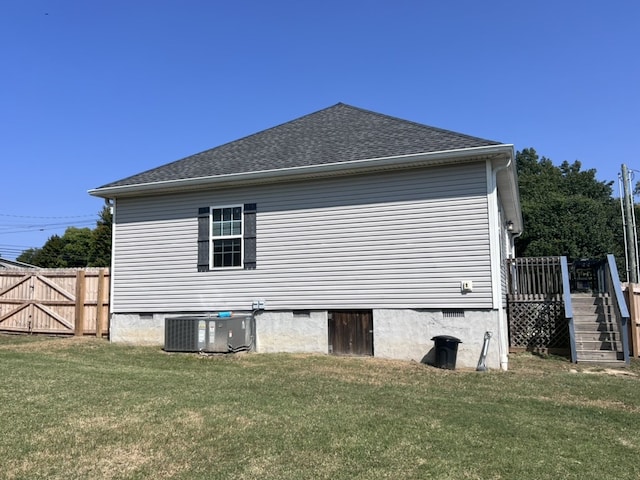 view of home's exterior featuring a yard and central AC unit