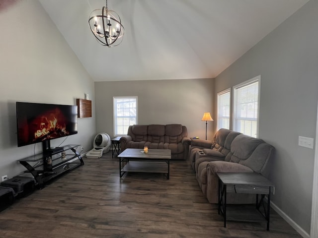 living room featuring dark hardwood / wood-style flooring, high vaulted ceiling, and a notable chandelier