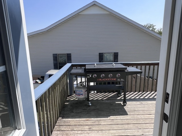 wooden terrace with a grill