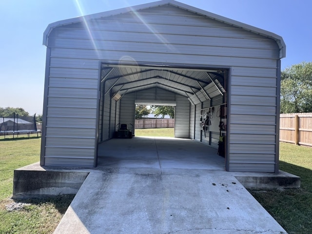 garage with a carport and a yard