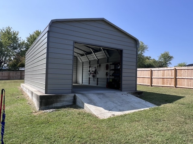 view of outbuilding with a lawn and a carport