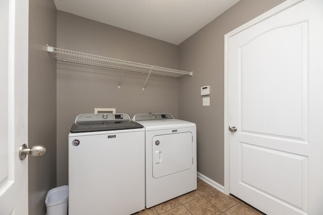 washroom featuring separate washer and dryer and light tile patterned flooring