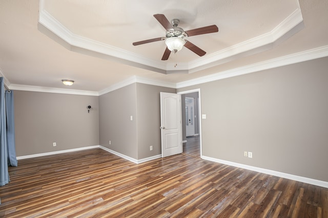 interior space featuring dark hardwood / wood-style flooring, a raised ceiling, and crown molding