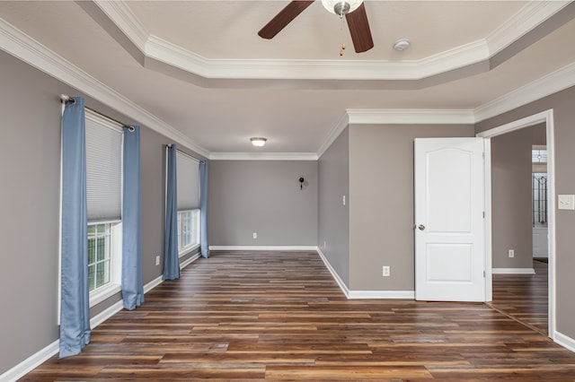 spare room featuring dark wood-type flooring and crown molding