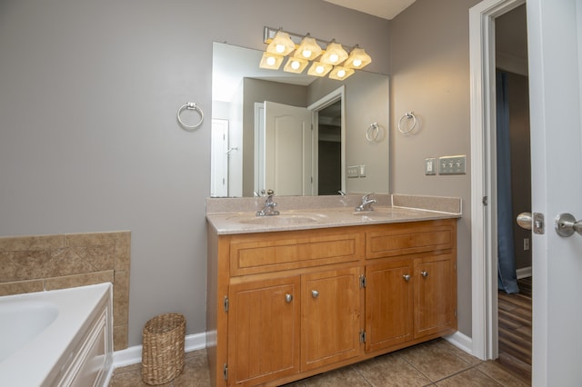 bathroom featuring tile patterned flooring, vanity, and a tub to relax in