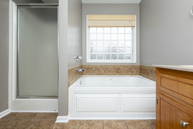 bathroom with tile patterned floors, vanity, and independent shower and bath