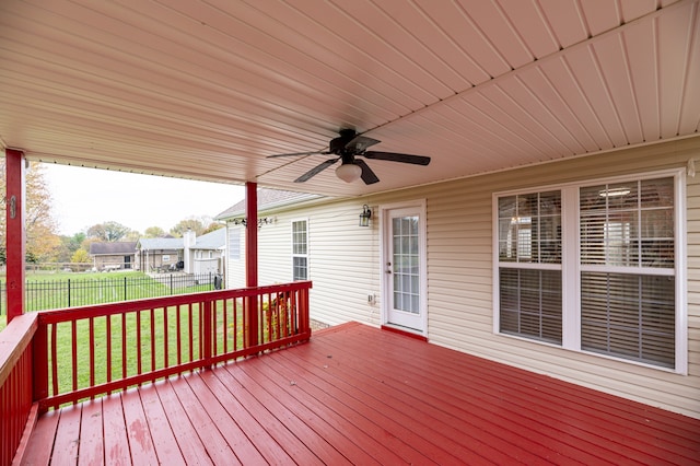 deck featuring ceiling fan and a lawn