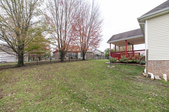 view of yard featuring ceiling fan and a wooden deck