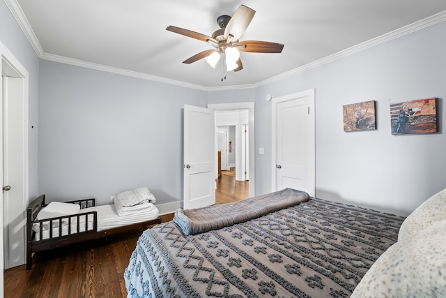 bedroom featuring crown molding, dark wood-type flooring, and ceiling fan